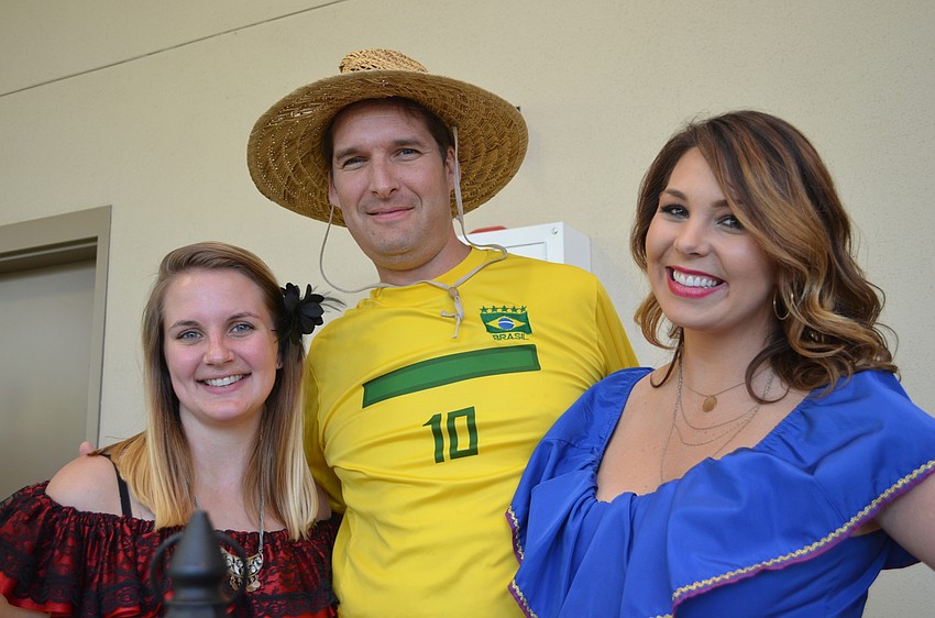 The booth for The Resort at Longboat Key Club took visitors south of the equator to Brazil. Brittney Nesmith, Jonathan Lester and Torri Brown.