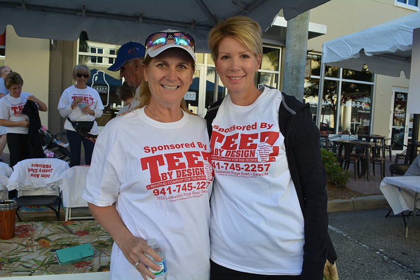 Sherri Patchen and Amy Amberg walk with the Palm Aire Country Club Partners team.