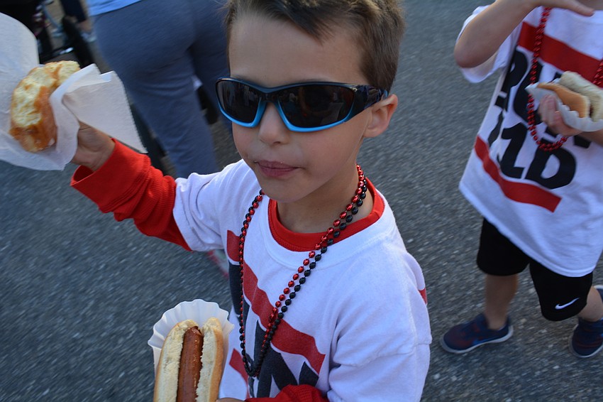 Jonathan Rose, 5, of Heritage Harbour, starts his pre-walk morning with a doughnut and a hot dog.