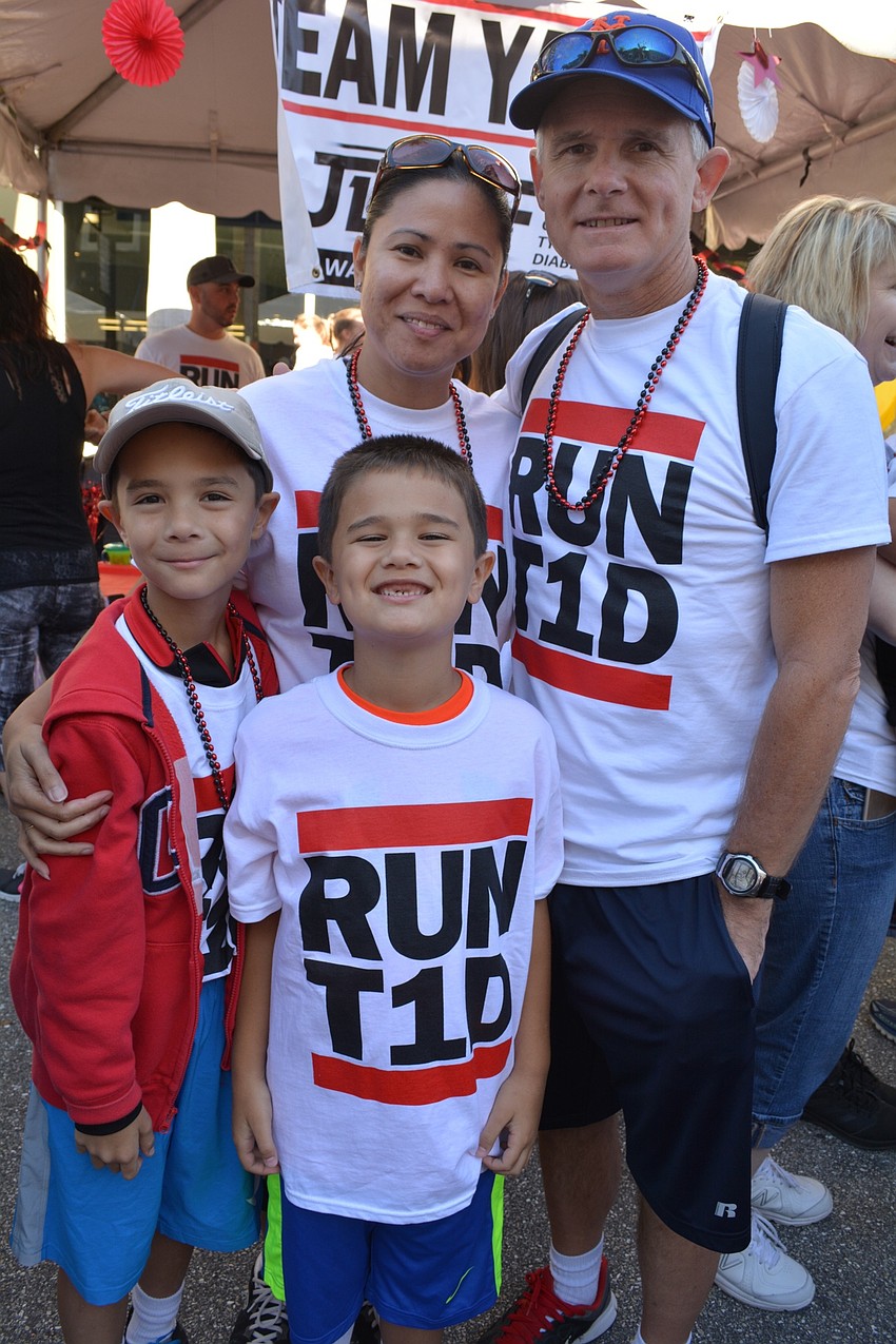 Mayeth and Gary Samler, of Heritage Harbour, walk for Team Yates with their children, Alex, left, and Brandon, right.