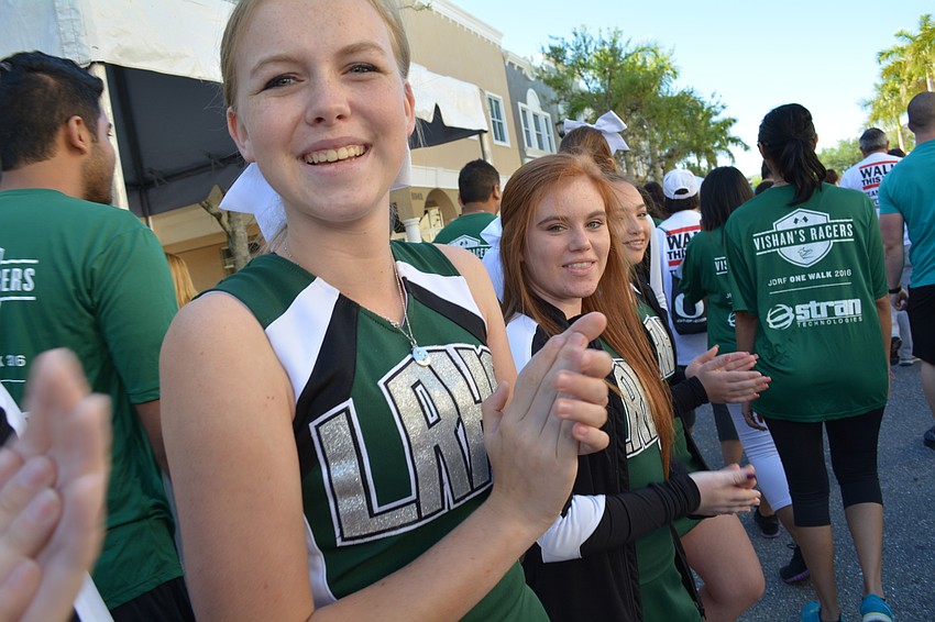 Freshman Lakewood Ranch High School cheerleader Mackenzie Brielman (with Payton Rypel behind her) lines the starting area to cheer for walkers.