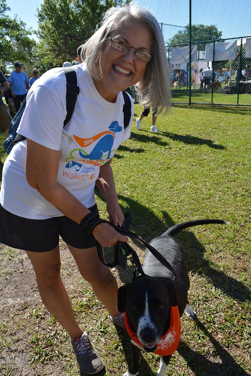 East County resident Debbie Bell, of Sabal Harbour, walks with her dog, Zoey.