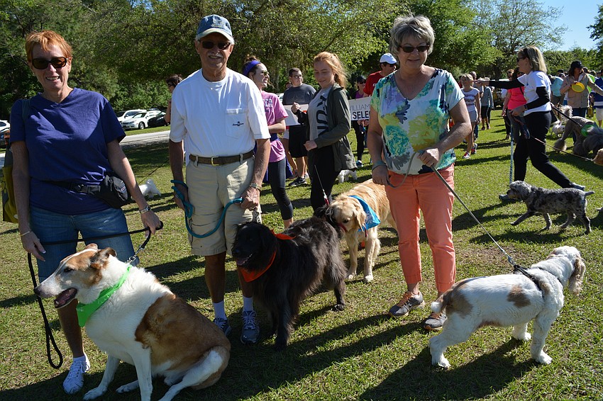 Pam an Bob Weigert, of Lakewood Ranch, walk with their dogs, Shiloh and Luna, and friend Sharon Thompson, with her dog, Chelsea.