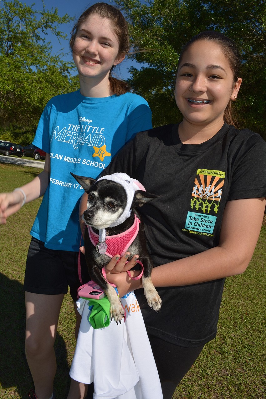 Lindsey Lymbach and Sofia Fonseca, students at Nolan Middle School, show off Sofia's dog, Katie. 