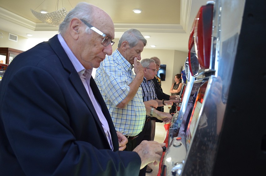 Howie Friedman takes his turn playing the slot machines.