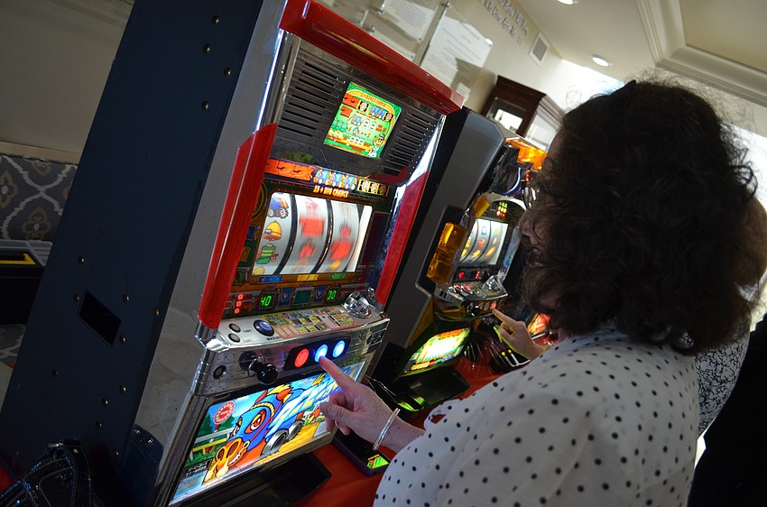 Maxine Greenberg takes her chances on the slot machines.