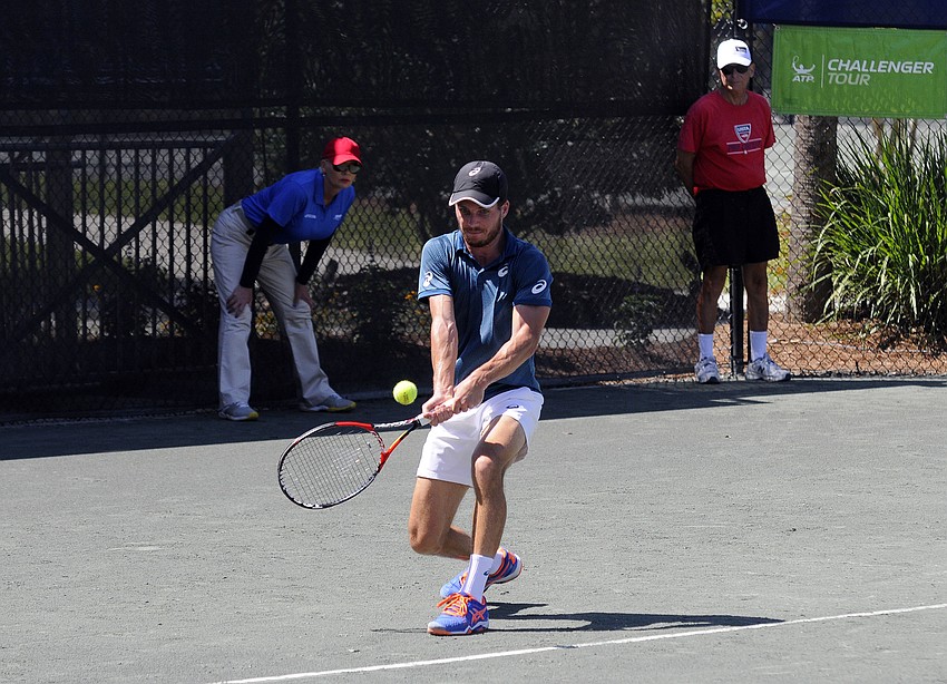 France's Axel Michon returns a serve during his final qualifying match April 11.
