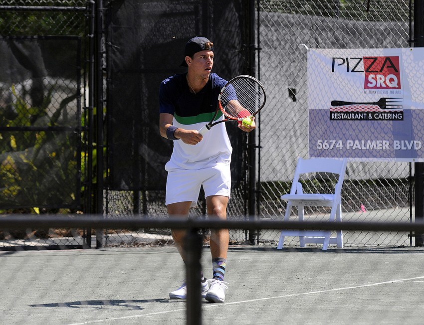 Jose Hernandez-Fernandez of the Dominican Republic prepares to serve the ball during the first set of his qualifying singles final.