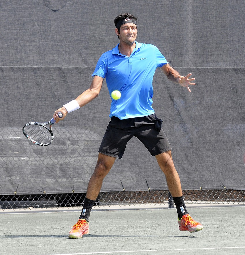 El Salvador's Marcelo Arevalo hits the ball back over the net during his qualifying singles final April 11.