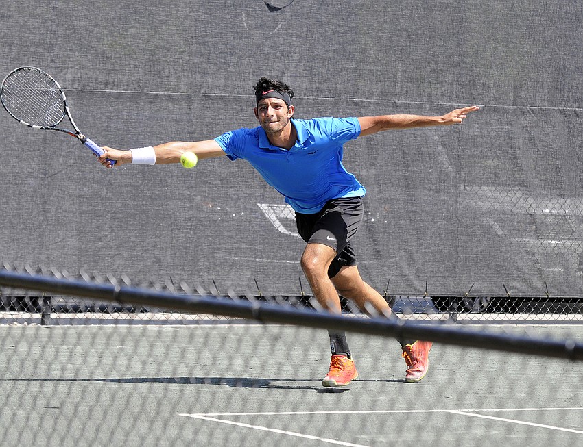 El Salvador's Marcelo Arvelo races to the ball in the first set of his qualifying singles match.