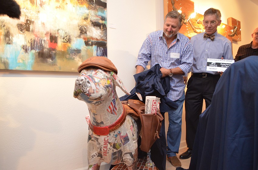 Artist David Steiner pulls back the sheet to unveil 