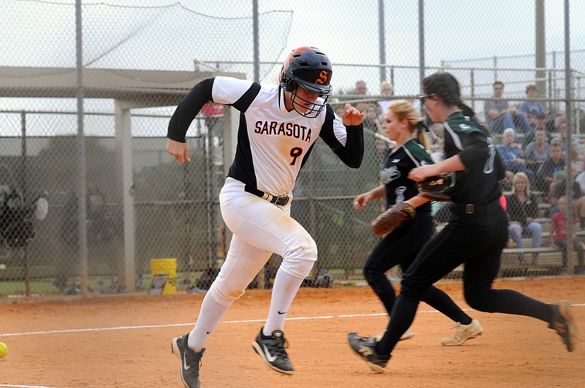 Sarasota senior SarahBeth Wengerd races down to first base after hitting a bunt in the first inning.