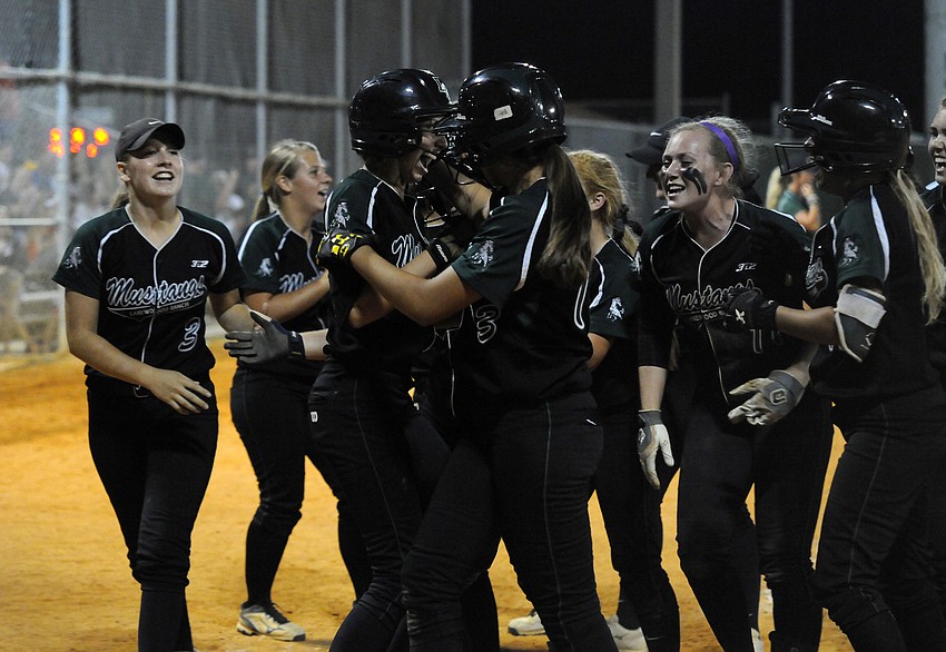 Lakewood Ranch junior Denali Schappacher is congratulated by her teammates following her solo home run.