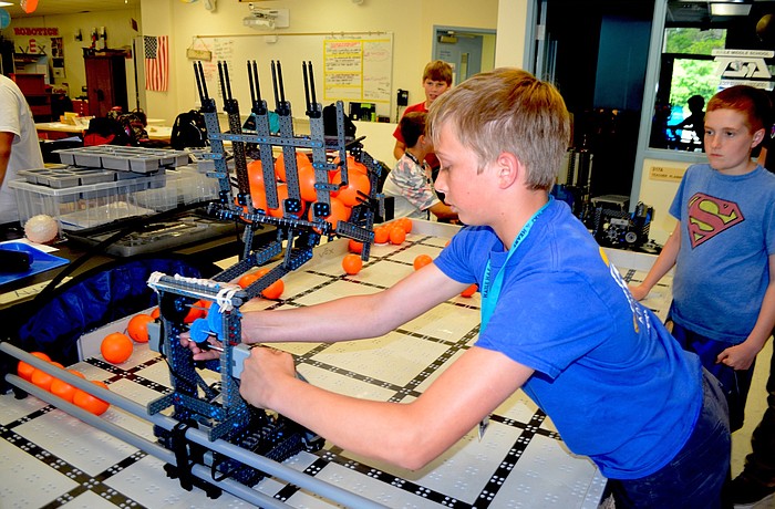 Haile Middle student Trevor Davis fine tunes a robot his group will bring to the VEX Worlds competition.