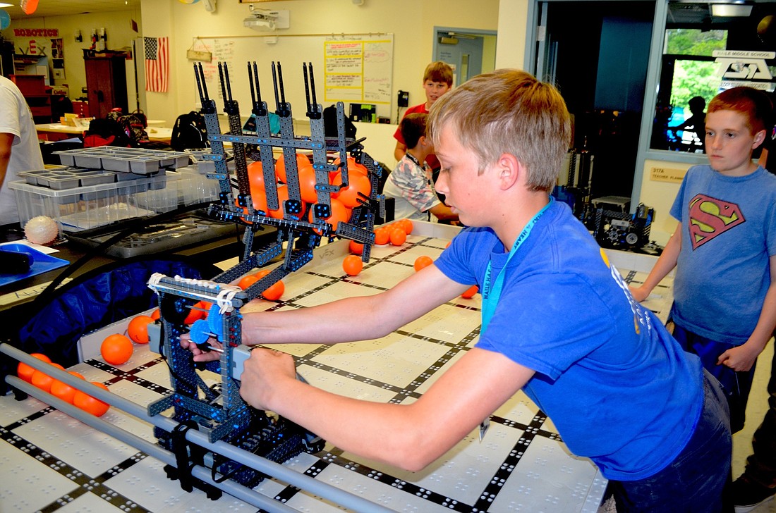 Haile Middle student Trevor Davis fine tunes a robot his group will bring to the VEX Worlds competition.
