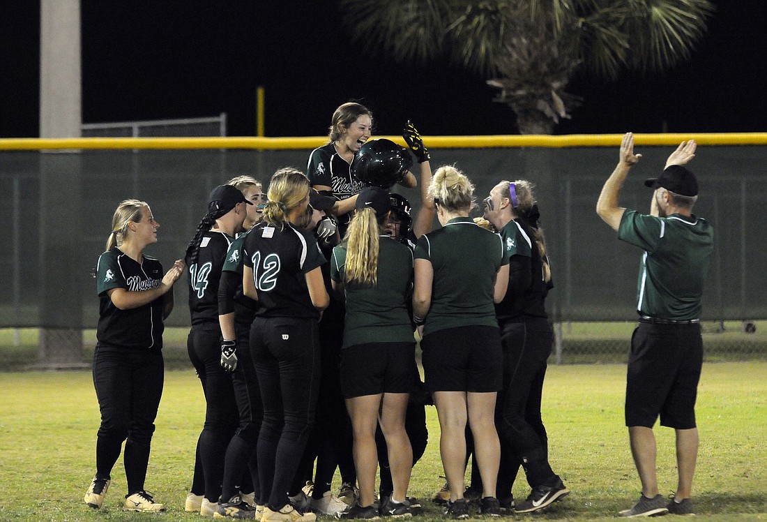 Lakewood Ranch junior Denali Schappacher celebrates with her teammates after hitting her first over-the-fence home run during the Class 8A-District 8 championship April 14.