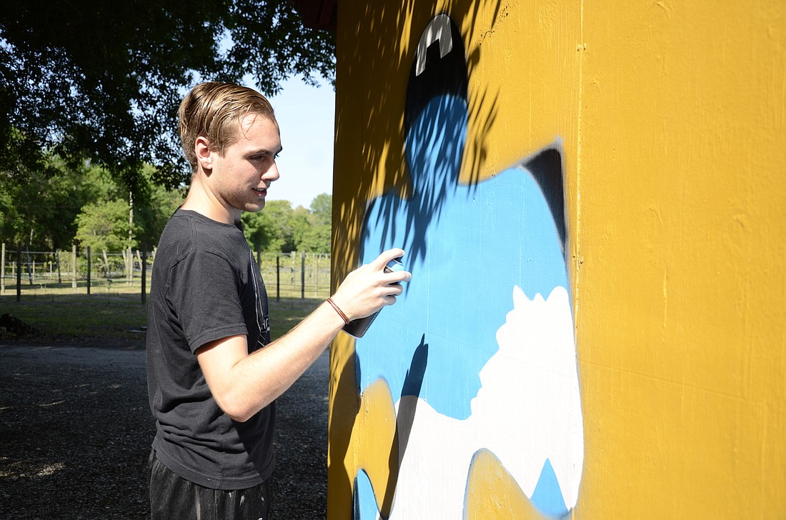 Ringling student Tyler Lefebvre adds color to his mural.
