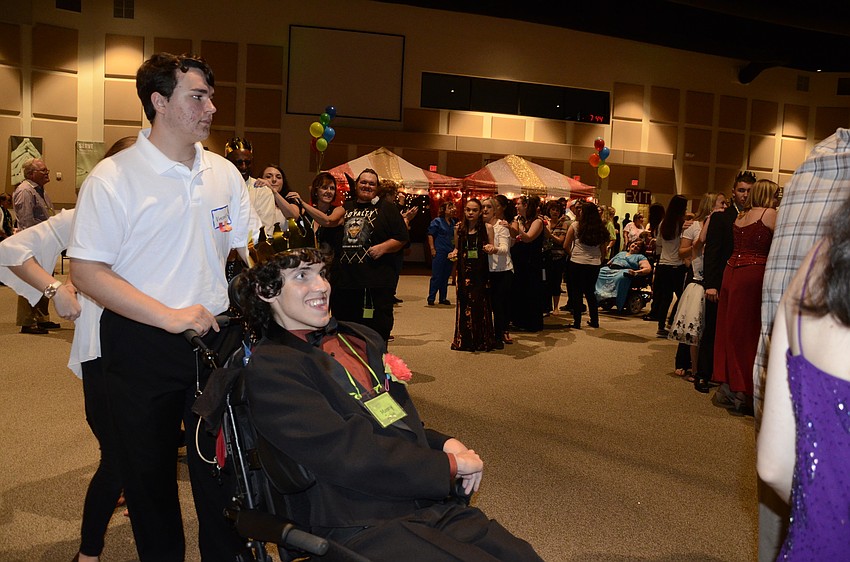 Braden River High School Key Club volunteer Vincent Kersey and Manny Galan join in the train.