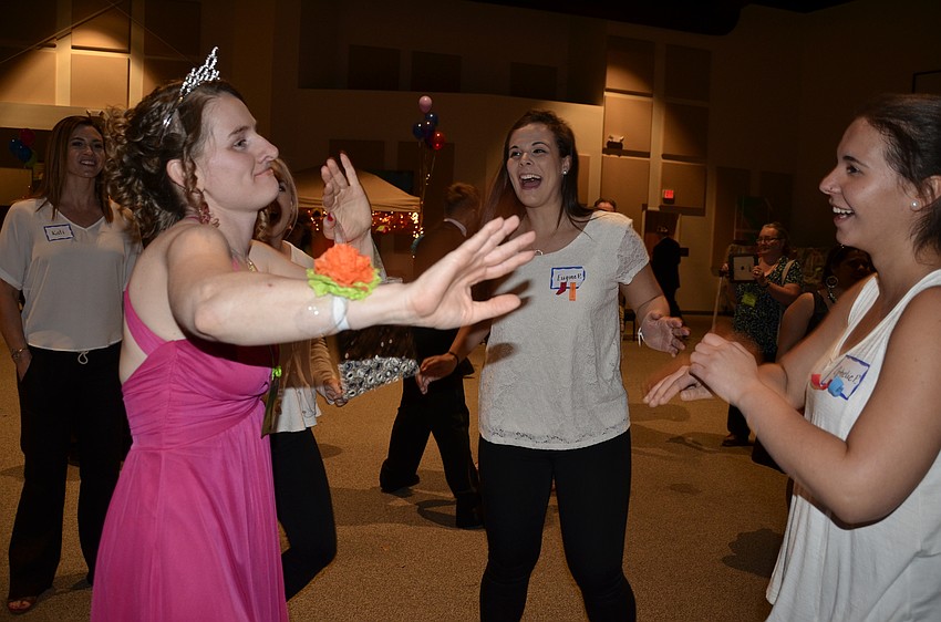 Laurel Audet of Lakewood Ranch dances with Eugine and Ophelie Portner, volunteers from Inspiration Academy.