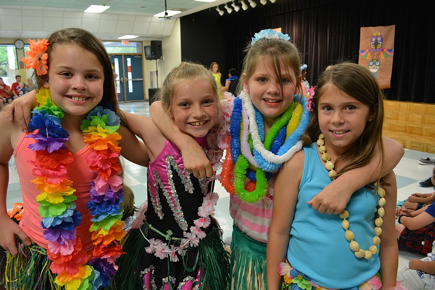 Briella Platt, Faith Geluso, Shae Schooley and Alexa Karr perform a hula dance with others in Tara's after-school program.