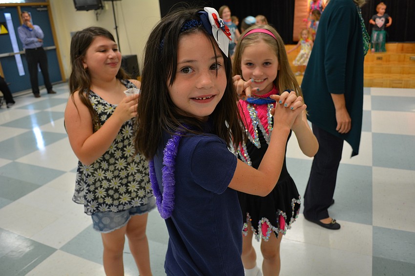 Chloe Meinczinger, front, dances with her friend, Lacey Fox, as Bella Alerico, left, watches.