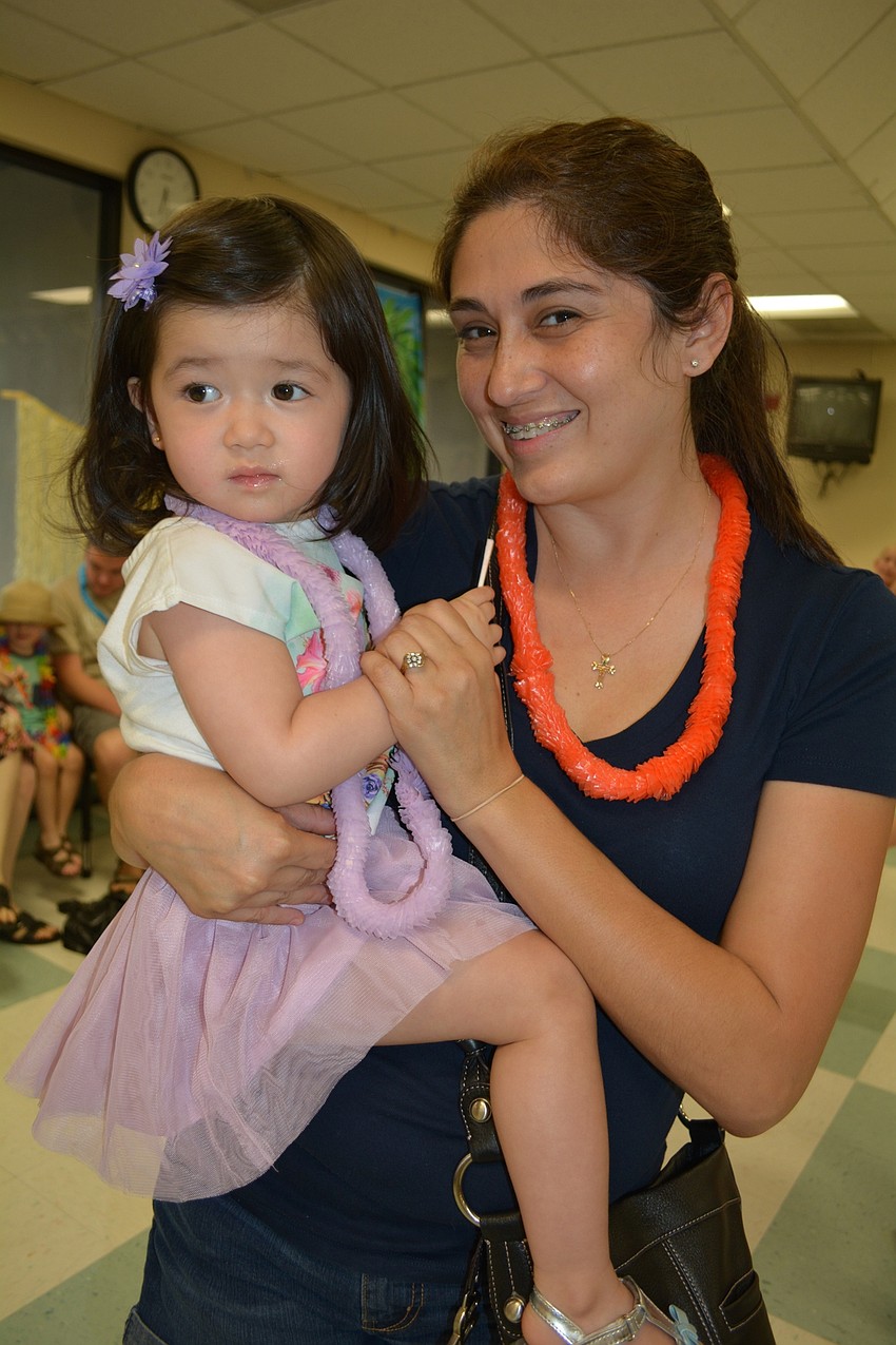 Two-year-old Elise Brughelli dances with her mother, Jennifer. They couldn't get her brother, Mason, 9, on the dance floor.