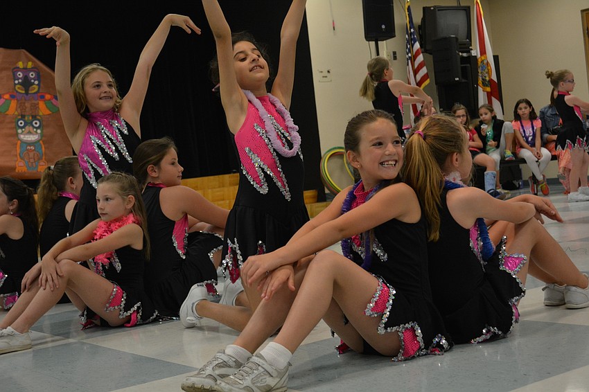 Elia Wilson, front, performs to 