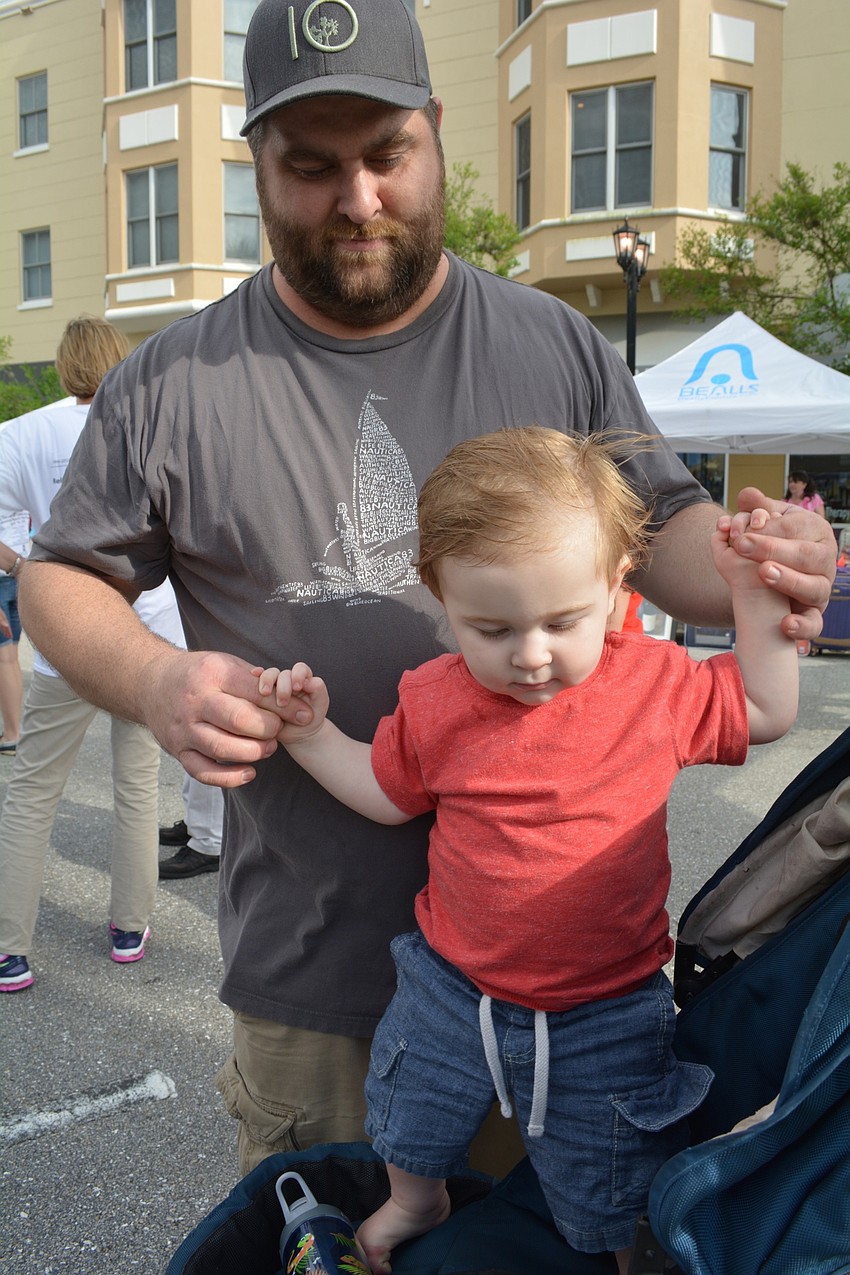 Jason Blom, 1, dances with the help of his dad, Dean.