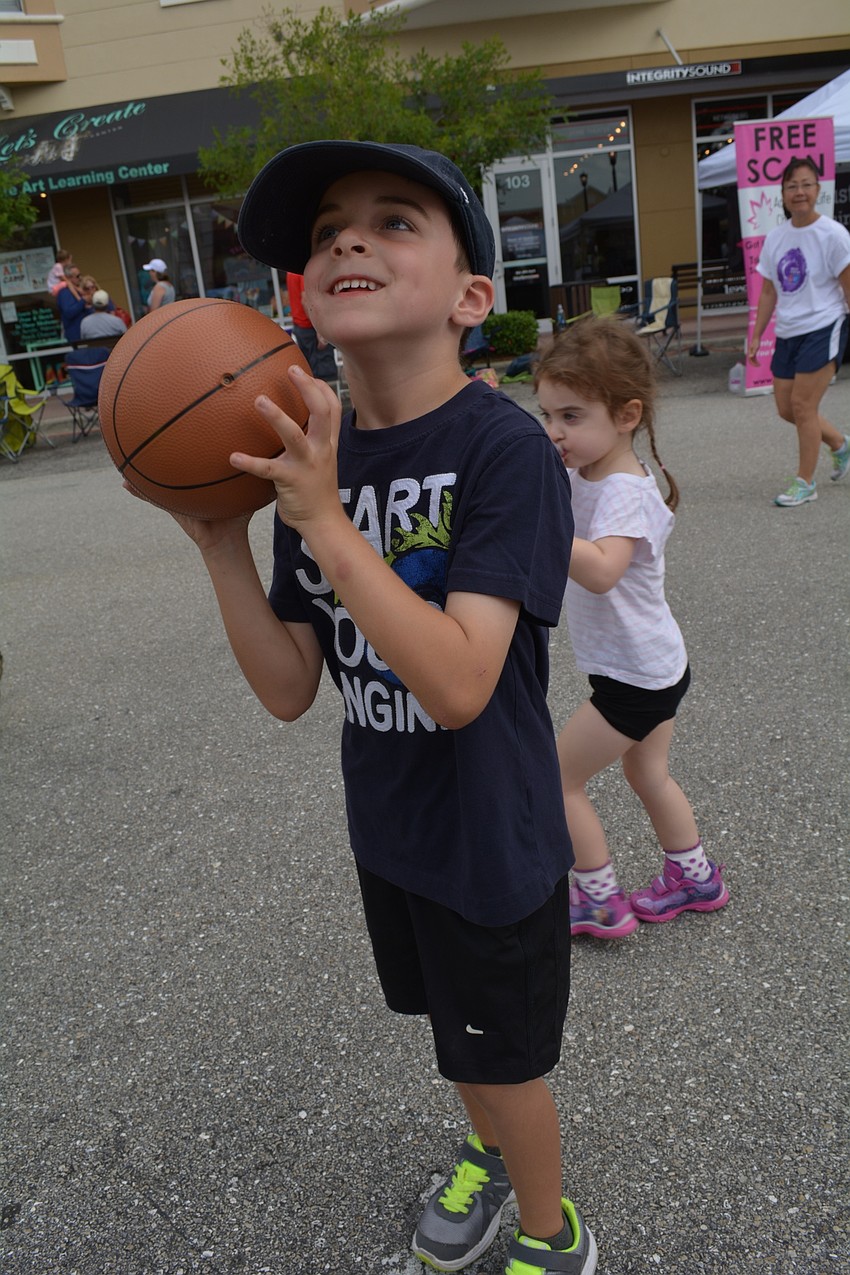 Mill Creek's Beckett Smith, 6, tries his hand at a game of basketball.