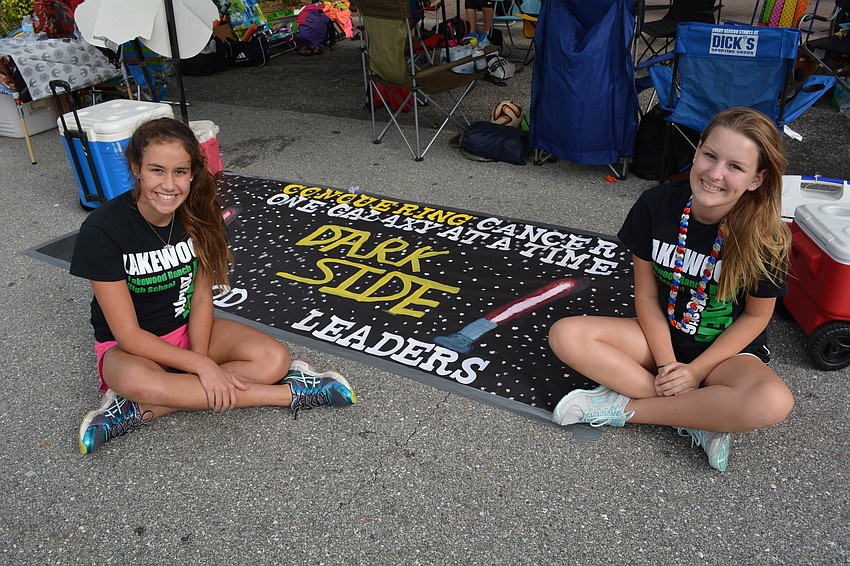 Alexa Montoya, 16, and Kaitlynn Baxley, 15, walk with Lakewood Leaders' 