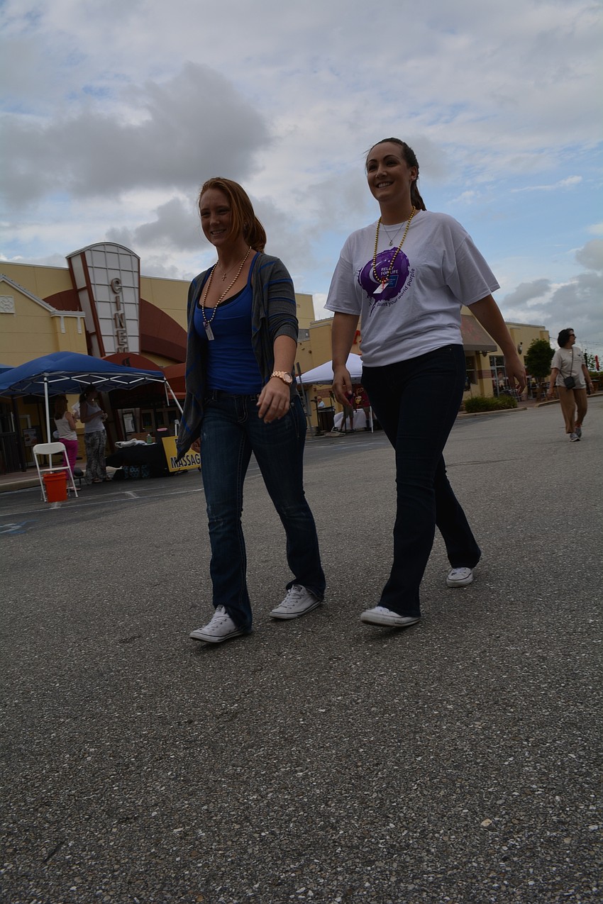 Ashley Wojciechowski and Marrisa Holbrook, of Ellenton, walk with the Ritz Carlton Lions team.