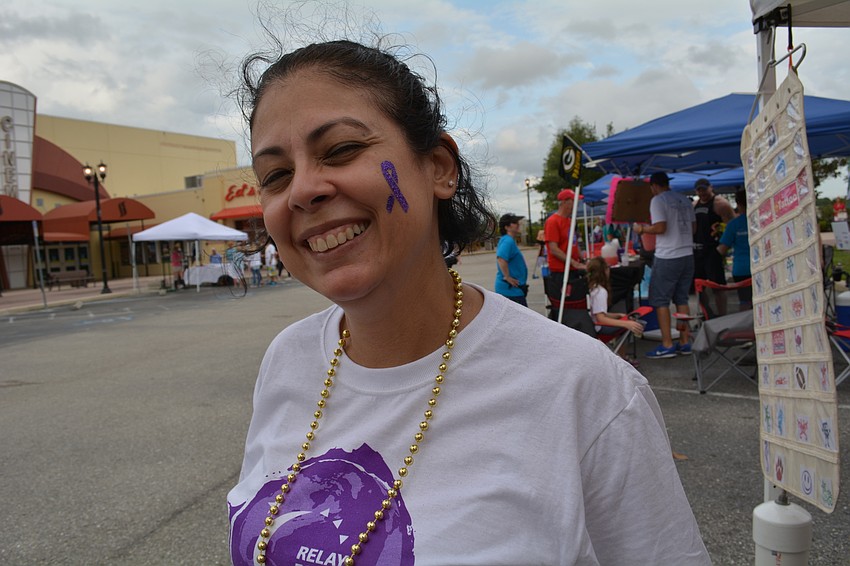 Belinda Kowalksi, of Sarasota, doesn't mind that her glitter tattoo will be on her face for at least three days after the event.