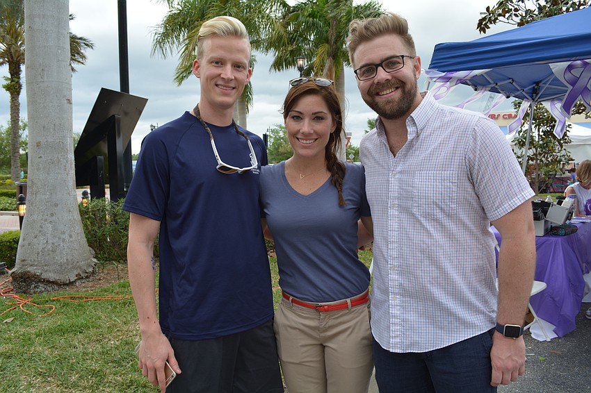 Daniel Blount, Elizabeth Hinton and Clay Kearney  walk with a team from the Ritz Carlton.