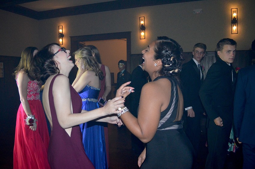 Alexa Kess and Rashona Banks laugh with friends while dancing.