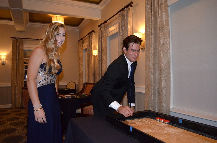Allison Drzewucki cheers on Parke Phillips during a fast game of shuffleboard.