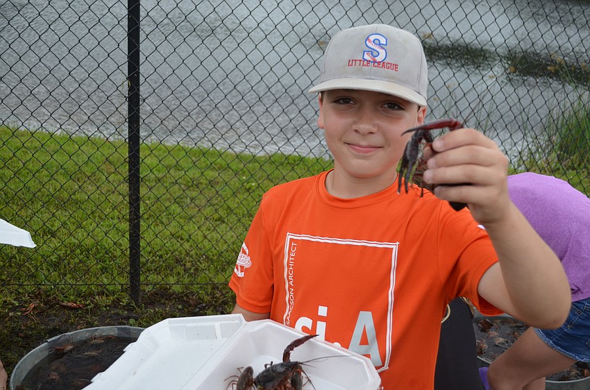 Anthony Izzo picks out a few crawfish to take home and make his pets.