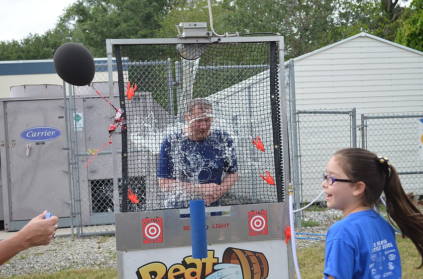 St. Martha Catholic School music teacher Samuel Francis was on the receiving end of a pitch in the dunk tank from Ana Martinez-Montanez