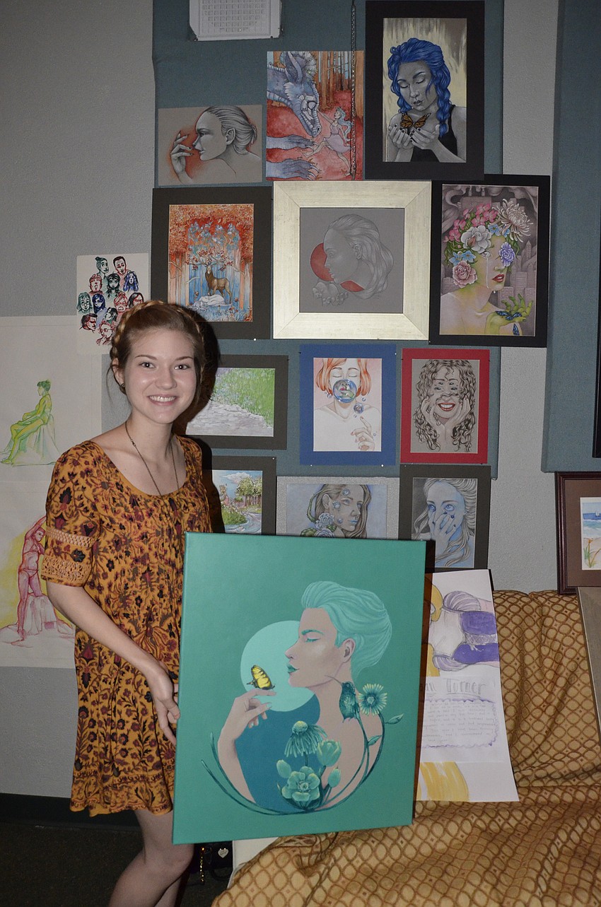 Reagan Turner, senior, displays her colorful portfolio. Her concentration was in illustration.