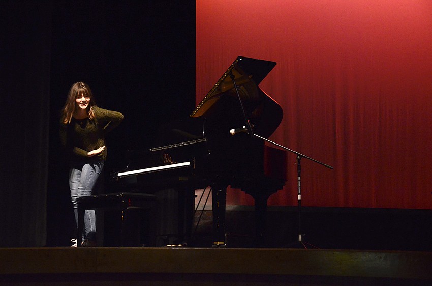 Julia Franck bows after her solo piano performance.