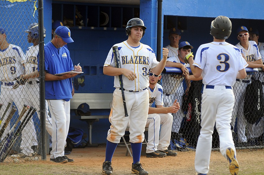 Sarasota Christian's Teddy Mullet congratulates Blake Schlabach after he scored the go-ahead run in the first inning.