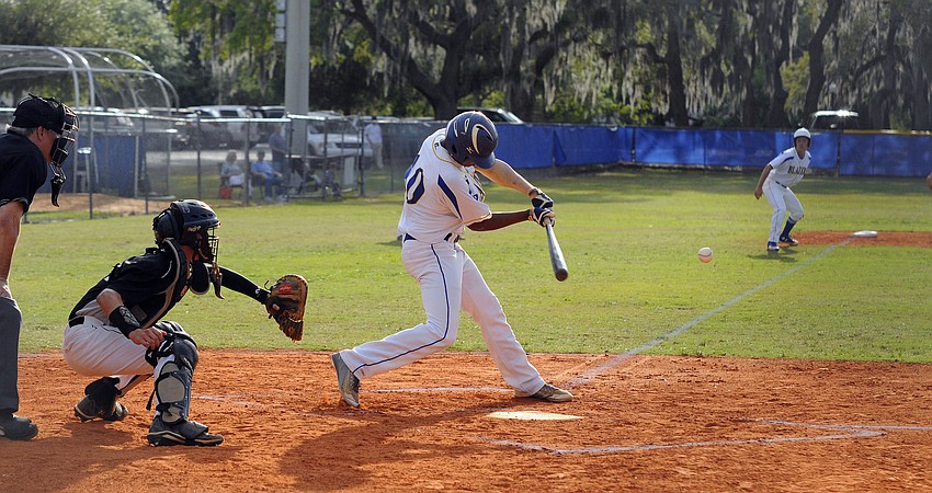Junior Hunter Clark makes contact in the first inning.