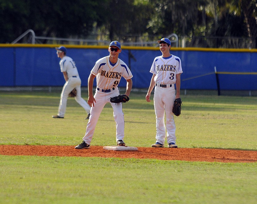 Infielders Trey Lantz and Blake Schlabach warm up between innings.