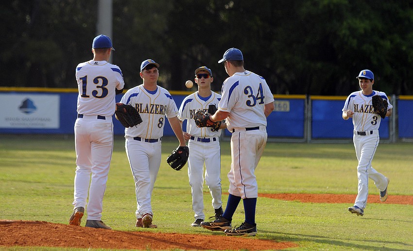 Pitcher Jordan Schmucker is greeted by infielders Trevor Byers, Trey Lantz, Teddy Mullet and Blake Schlabach before the start of the second inning.