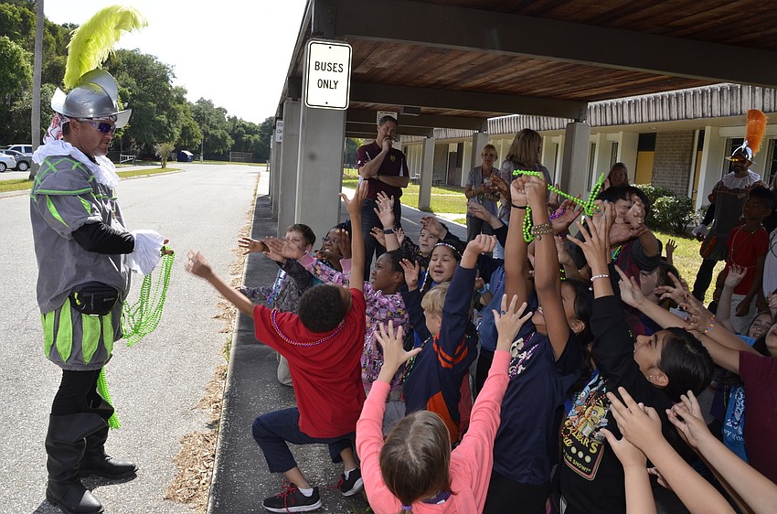 Erik Marshall quizzed the kids before he gave them beads — 