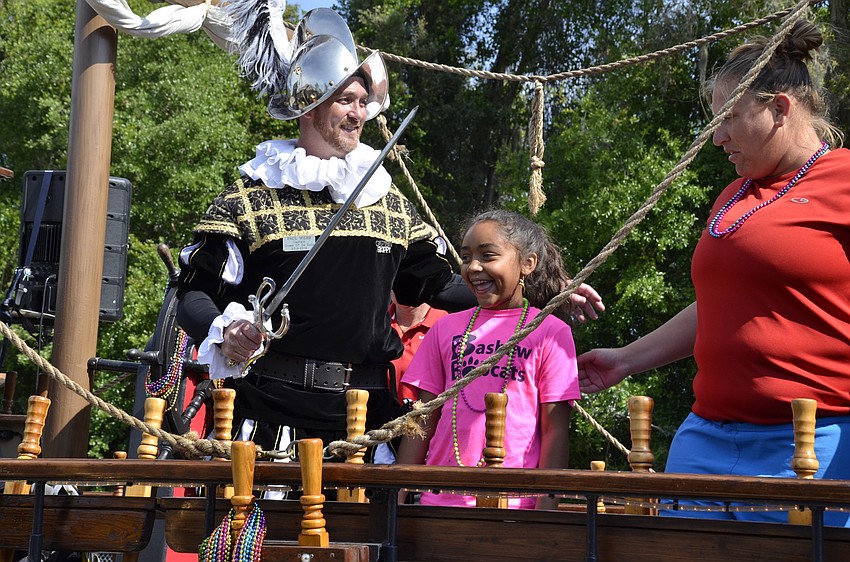 Captain Paul Webb with third-grader Jaelah Alexander and 