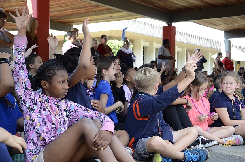 Kamara Clark raises her hand to answer a question.