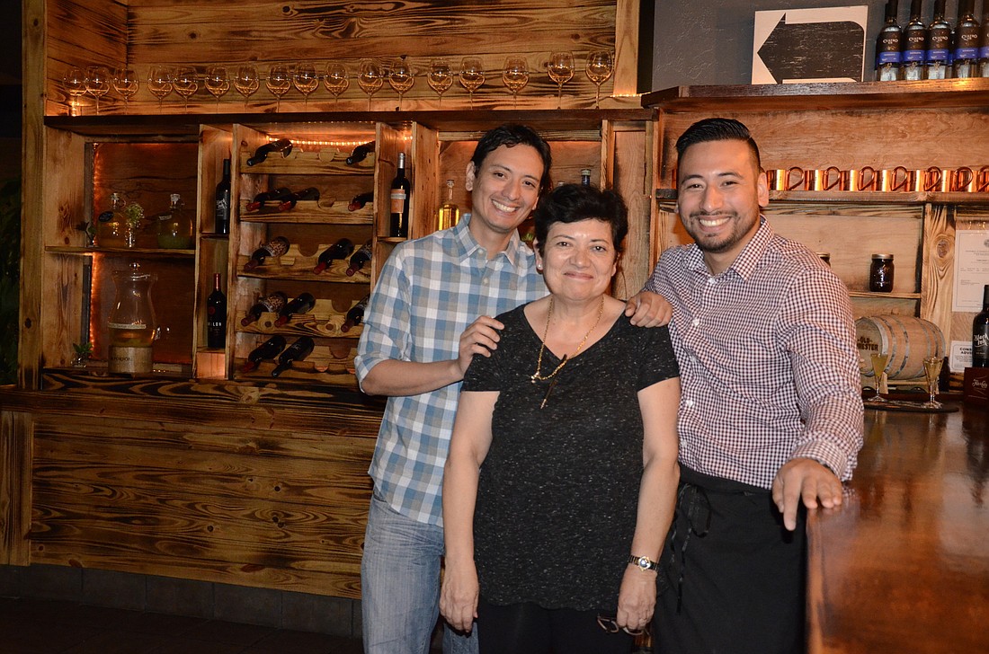 Mother Nancy Sekelsky with her sons, Dante and Luis Valenzuela. The three manage the restaurant together.