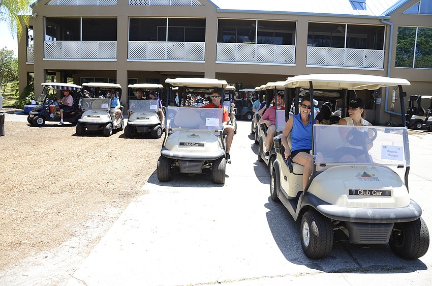 Golfers get ready to go in a shotgun tournament start.