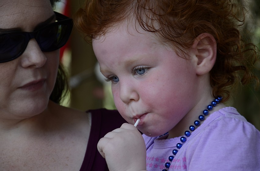 Stella Stults enjoys a lollipop with mom Amanda Stults of North Port.