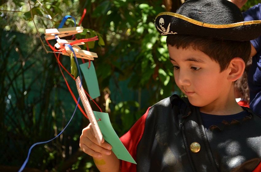 Aaron Gonzalez-Guerra reads wishes that visitors left on the tree.